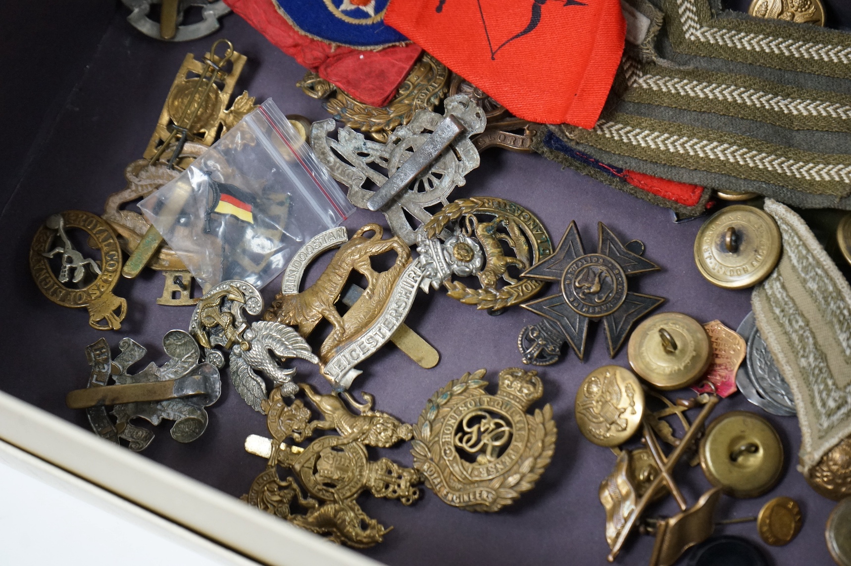 A collection of military medals and cap badges, etc. including
